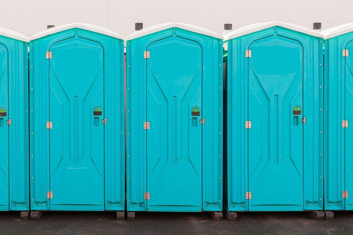 Row of clean portable toilets delivered to a job site in Somerville, MA